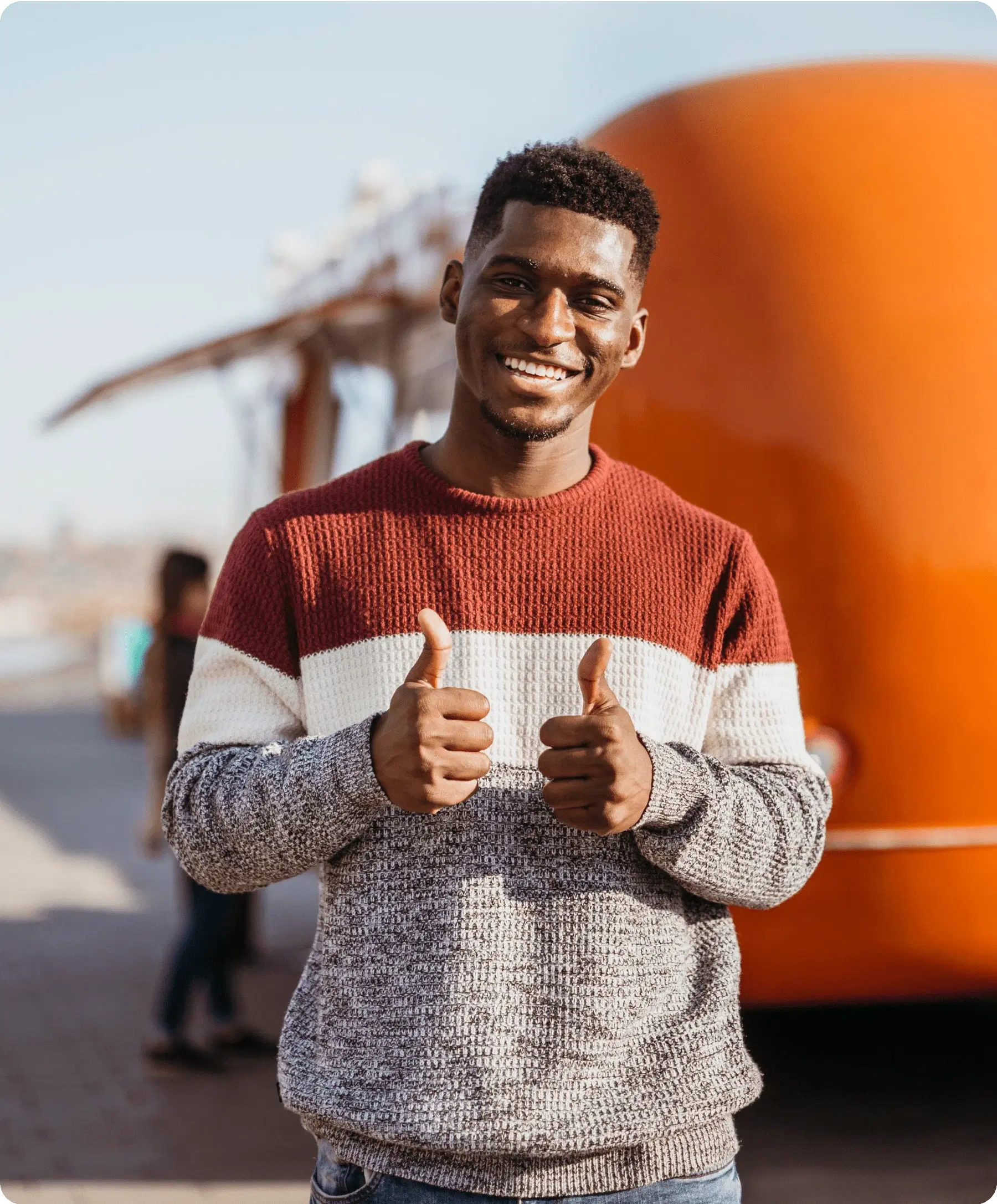 Smiling man giving thumbs up.